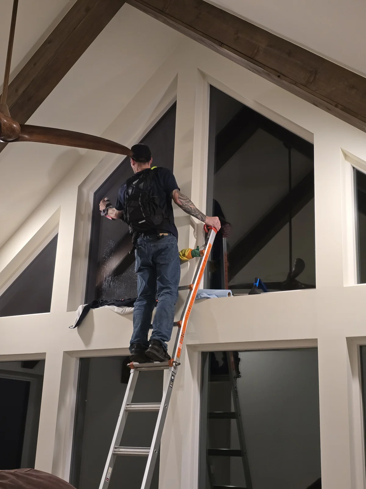 Precision architectural window film installation in progress on residential glass